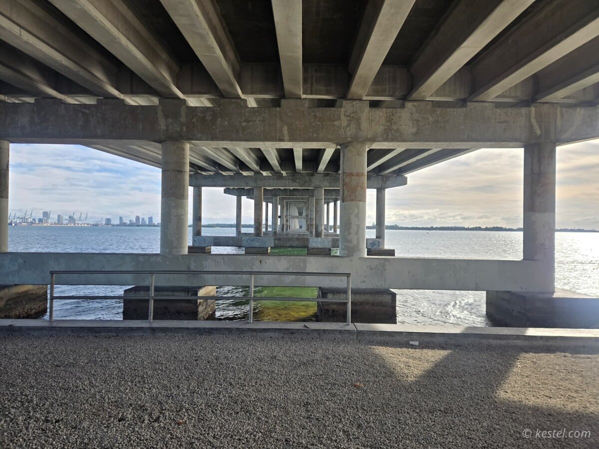 Geometric view under a concrete bridge with Miami skyline visible