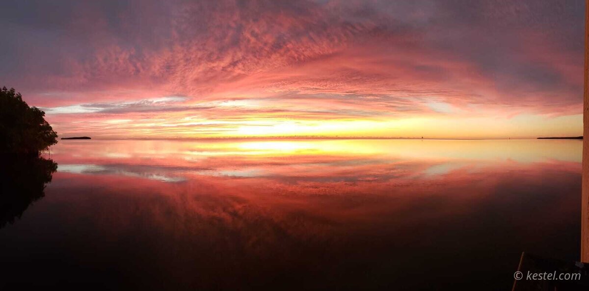 Wide panoramic pink sunrise over the bay