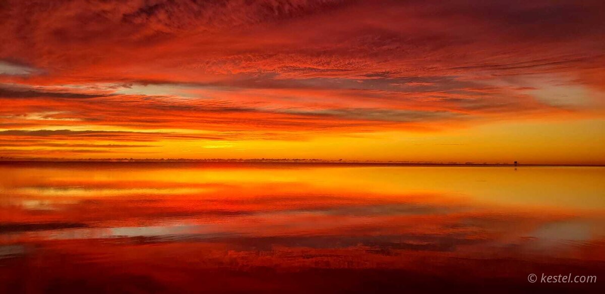 Pink and purple dawn sky over water