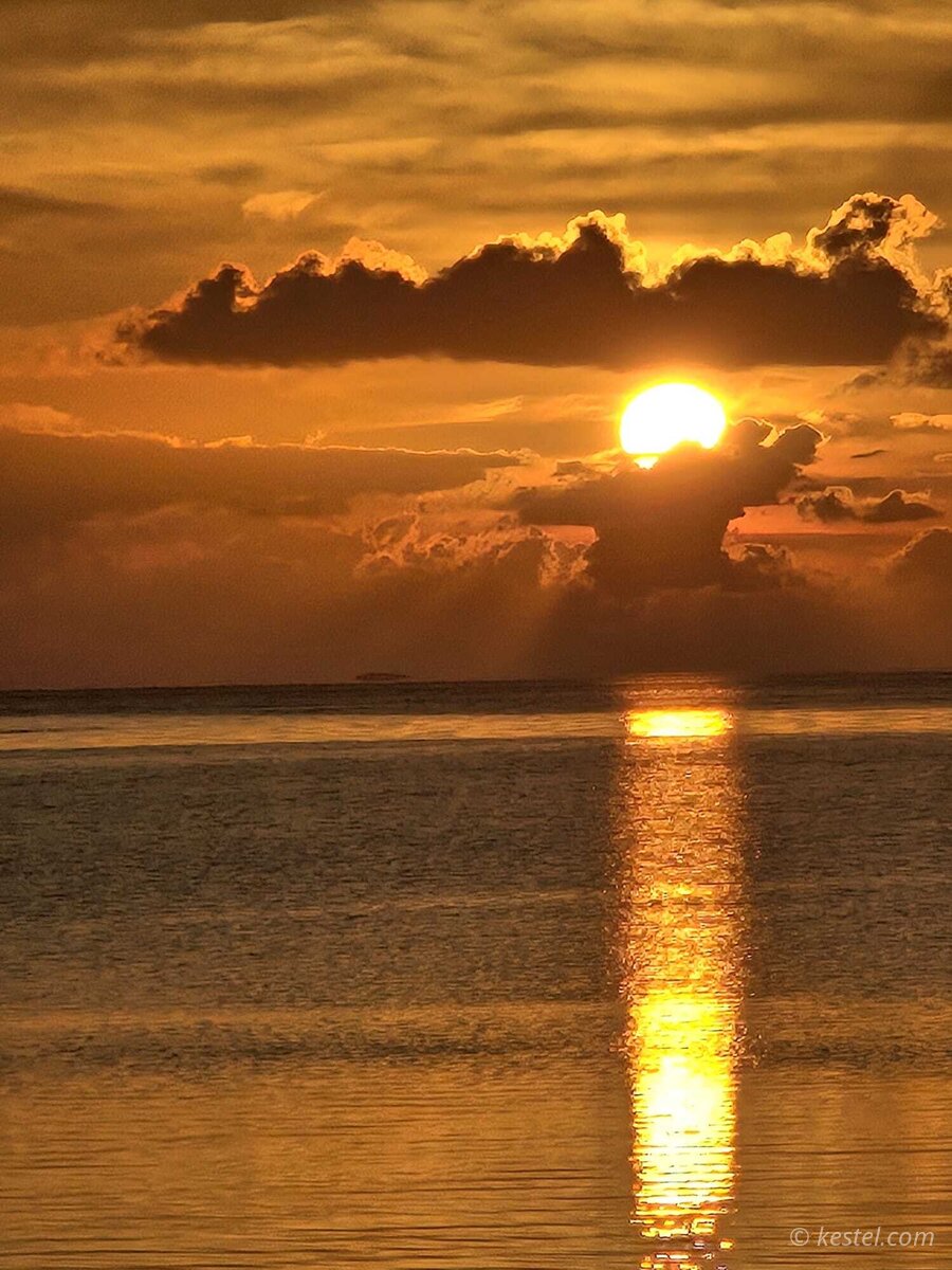 Dramatic cloud formation at sunset over open water
