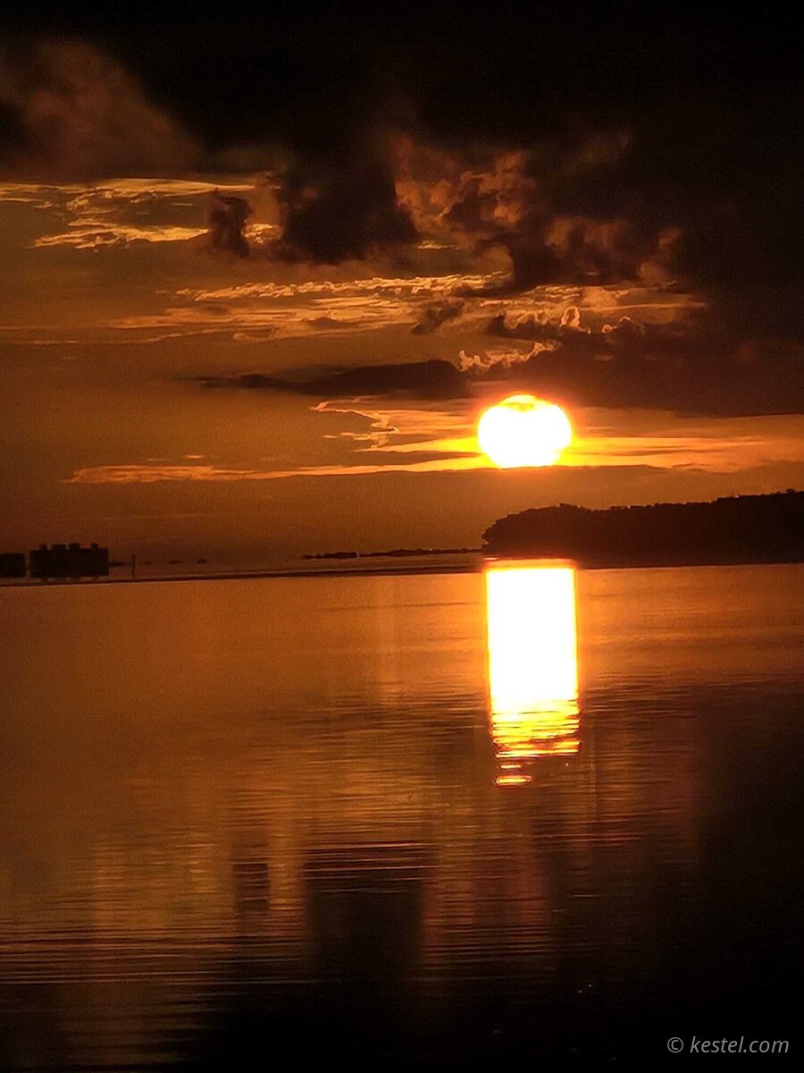 Full sun rising with bright reflection at Virginia Key